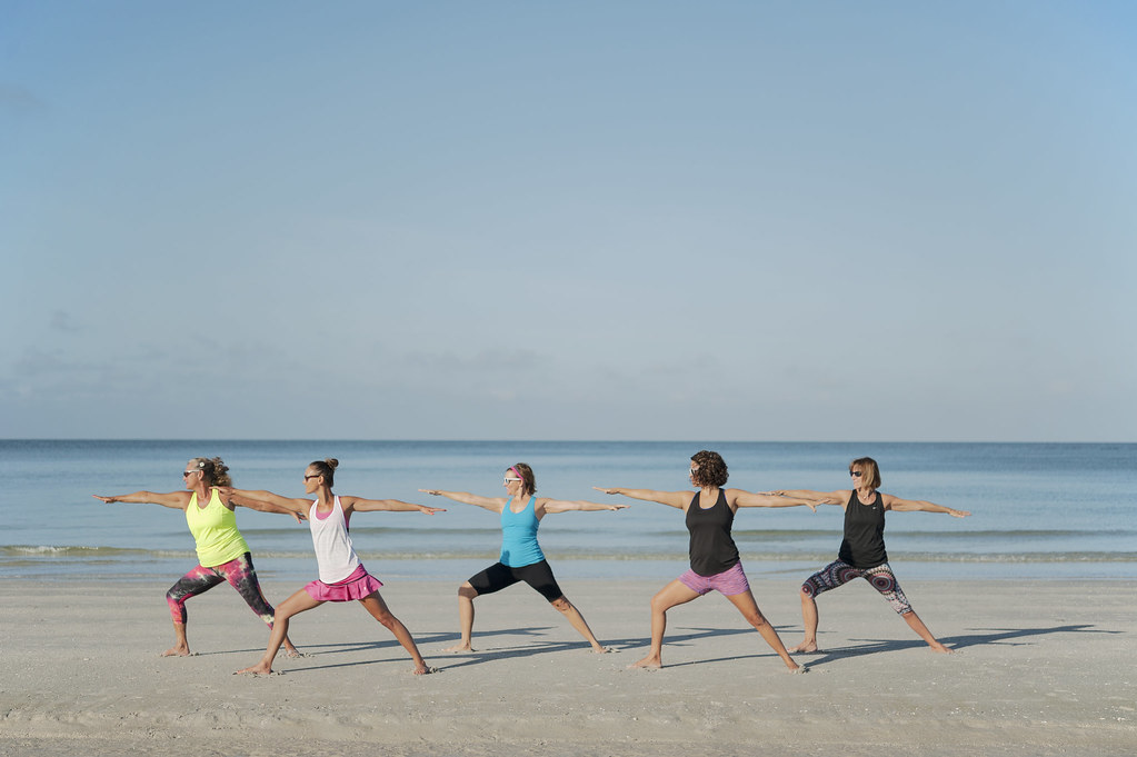 Group yoga class on the beach