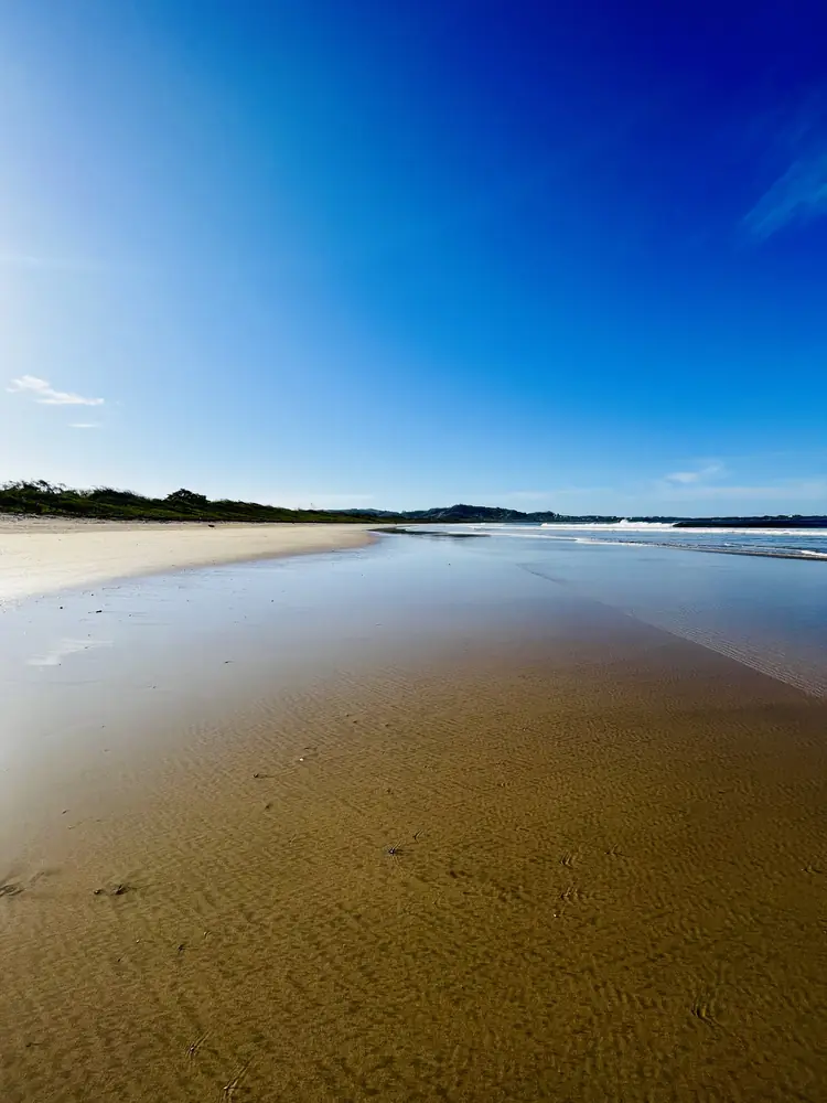 Deep blue sky over glassy sand