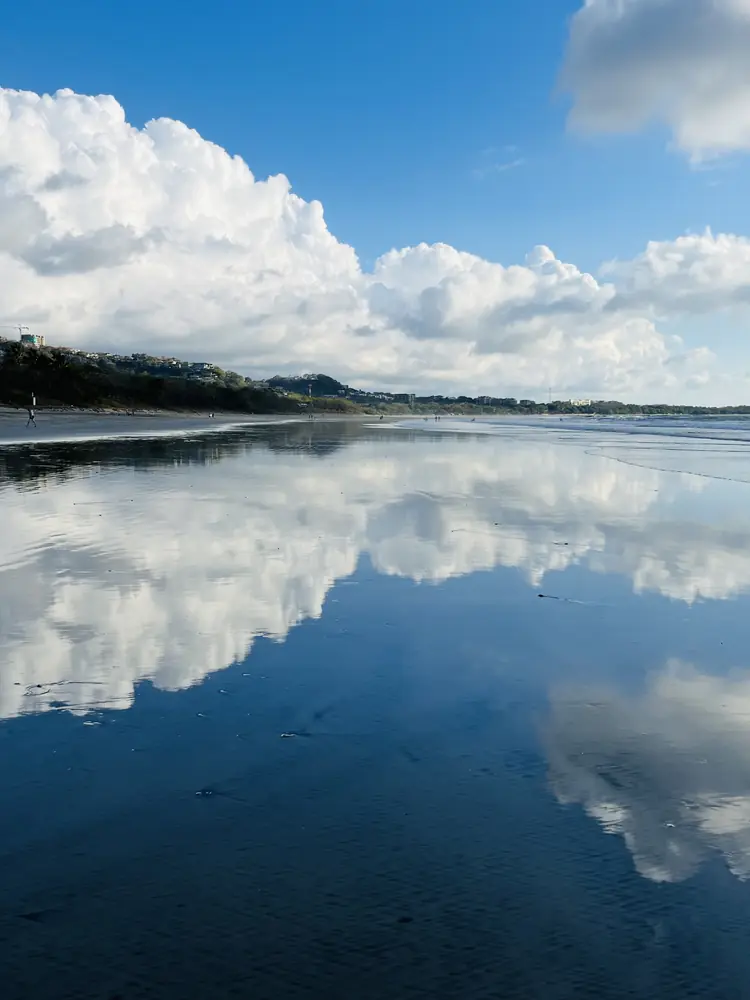Blue-sky clouds in the low-tide mirror