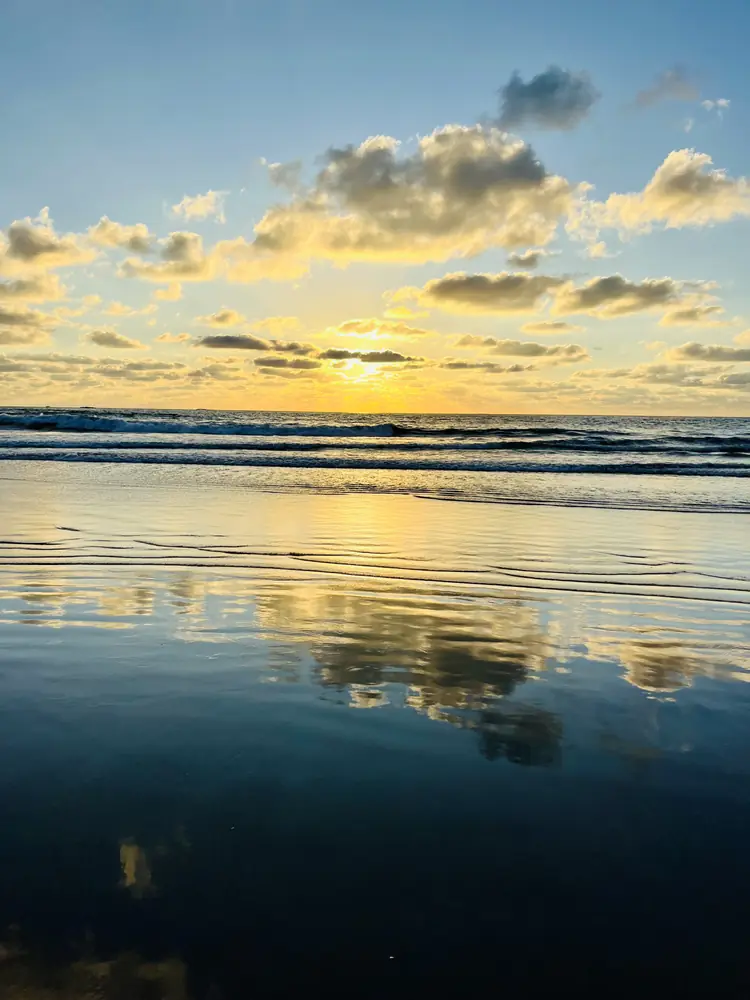 Golden clouds in the low-tide mirror