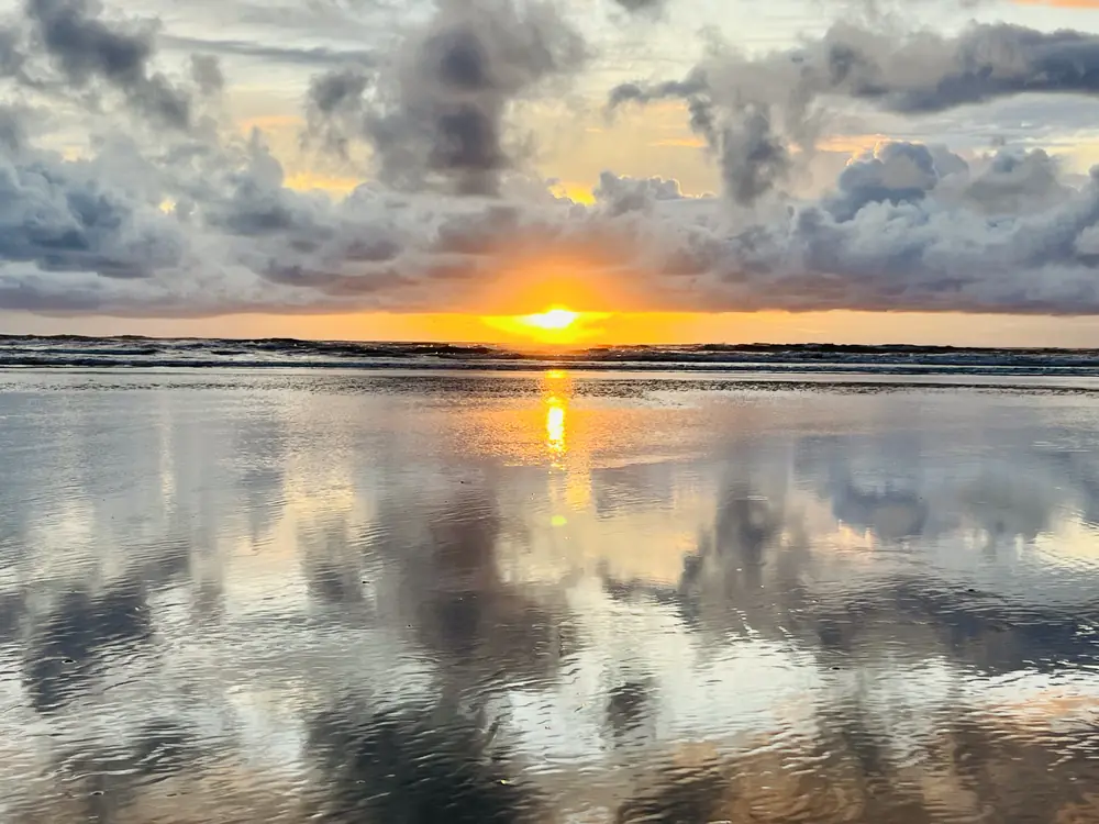 The sun setting between two skies