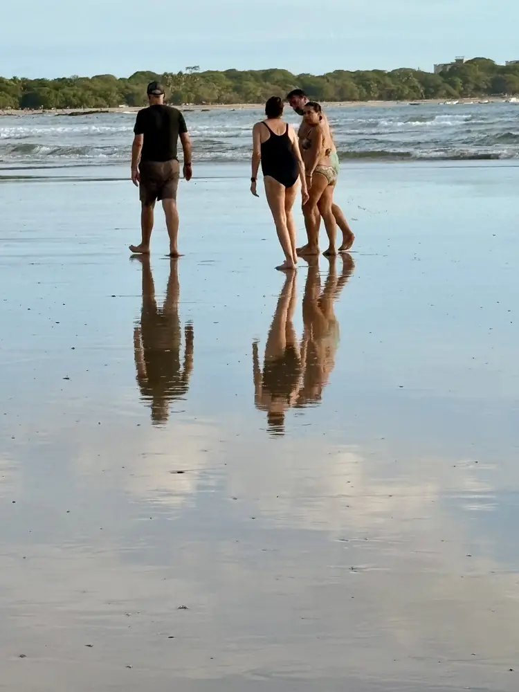 Friends reflected in the low tide