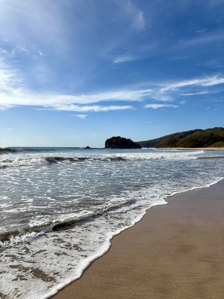 Waves rolling in on a blue day